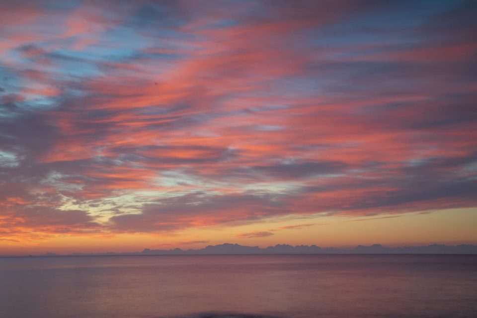 Die aufgehende Sonne beleuchtet die Federwolken von unten, eine Symphonie in Pastell, Mallorca